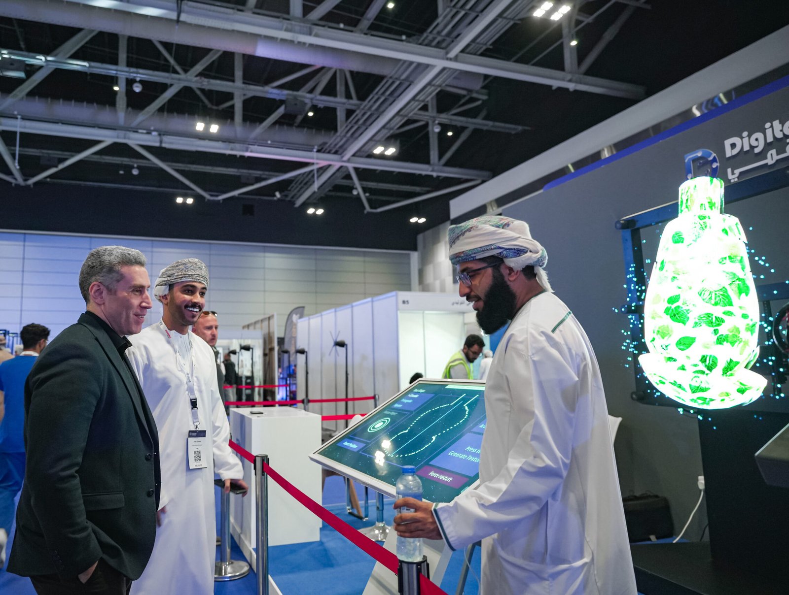 Attendees at the Oman Conference on Generative Artificial Intelligence interact with Digital Diffusion's 9-unit holographic wall, AI virtual assistant, and AI drawing app, showcasing the practical application of generative AI technologies